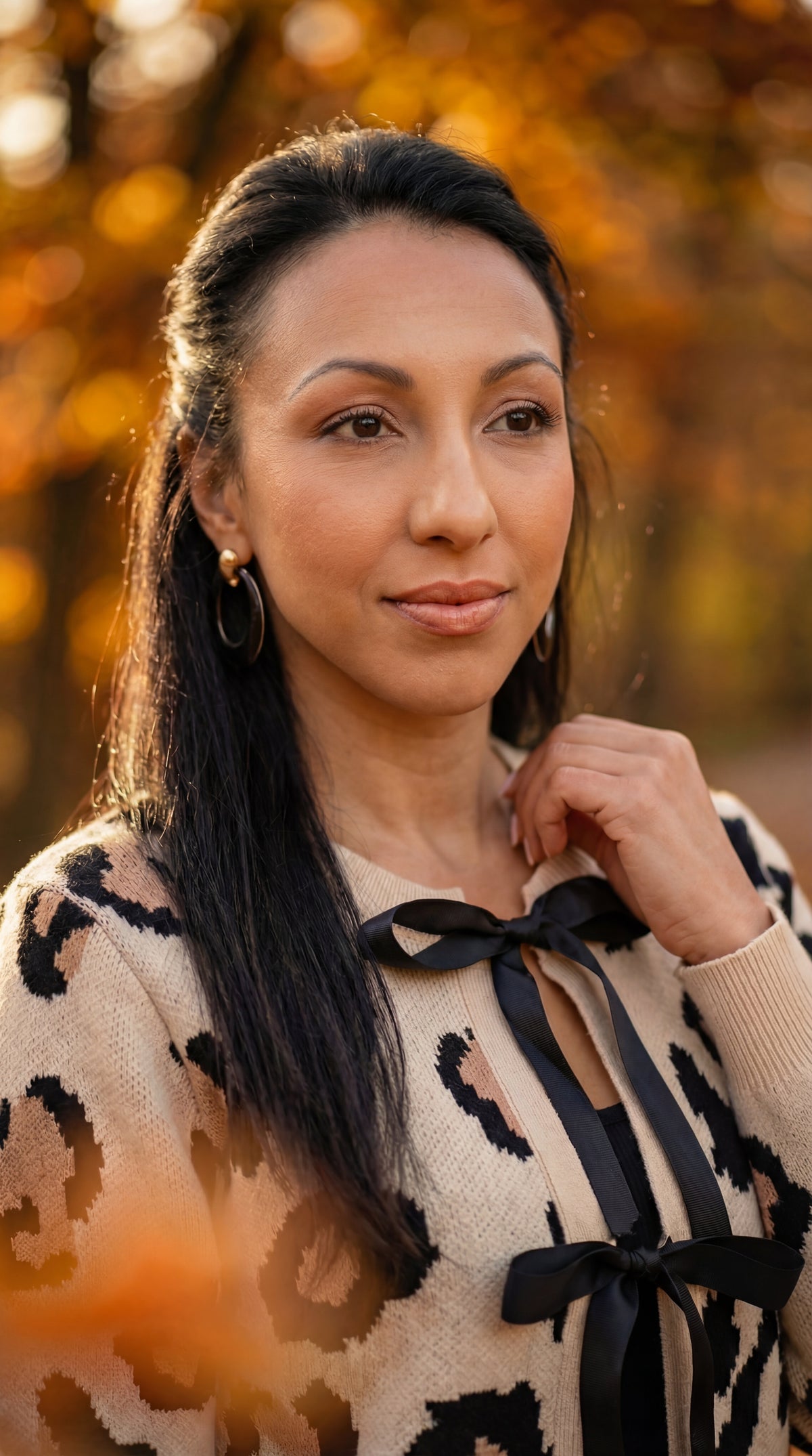 Close-up of the leopard cardigan neckline and black bow ties.